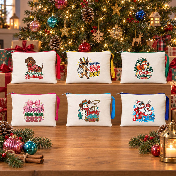 Six cream Christmas zipper clutch bags with red, yellow, green, fuchsia, turquoise and royal blue zippers and matching wrist straps on a wooden display in front of a decorated Christmas tree
