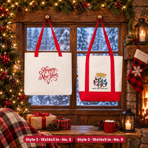 Two natural canvas New Year tote bags hanging by a snowy cabin window: Classic tote with red handles 18x14x3 in with Design No. 3 Happy New Year script and Trend tote with red trim 16x14x5 in with Design No. 5 penguins