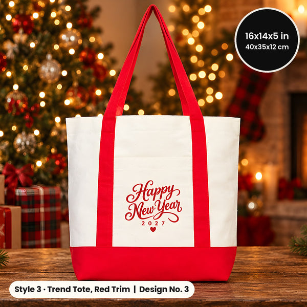 Canvas tote bag with red handles and red base printed Happy New Year 2027 in red script on a wooden table by a holiday tree and fireplace
