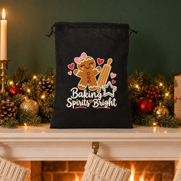 Black drawstring bag with a Baking Spirits Bright gingerbread print standing on a Christmas fireplace mantel with a garland, candles and stockings