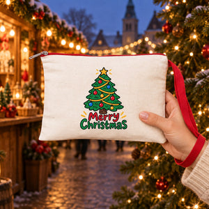 Hand carrying a cream wristlet clutch with a red wrist strap and a Merry Christmas tree print at a Christmas market, showing the real size