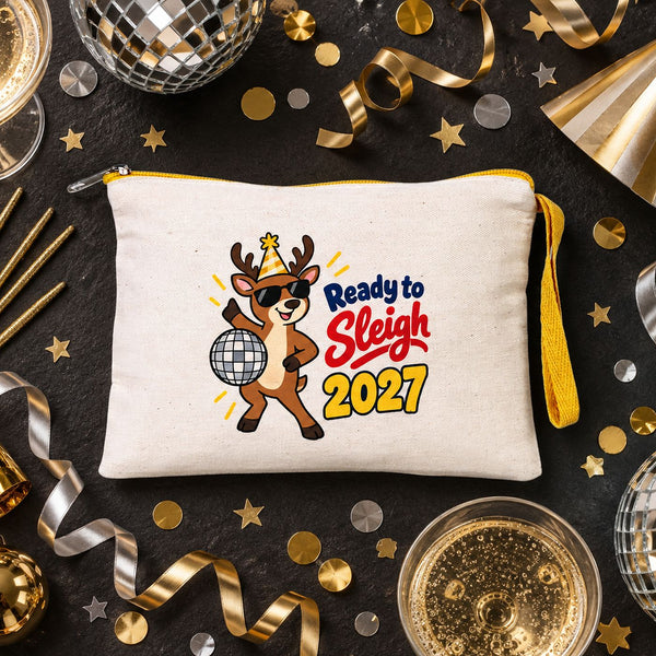 Cream zipper pouch with a yellow zipper and a Ready to Sleigh 2027 disco reindeer print on black slate with disco balls and confetti