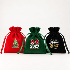 Three velvet drawstring pouches in red, green and black with gathered rose tops and satin ribbons, printed with Merry Christmas tree, buffalo plaid bow 2027 and Hello 2027 designs