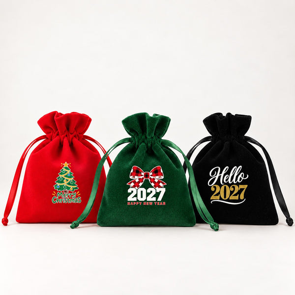 Three velvet drawstring pouches in red, green and black with gathered rose tops and satin ribbons, printed with Merry Christmas tree, buffalo plaid bow 2027 and Hello 2027 designs