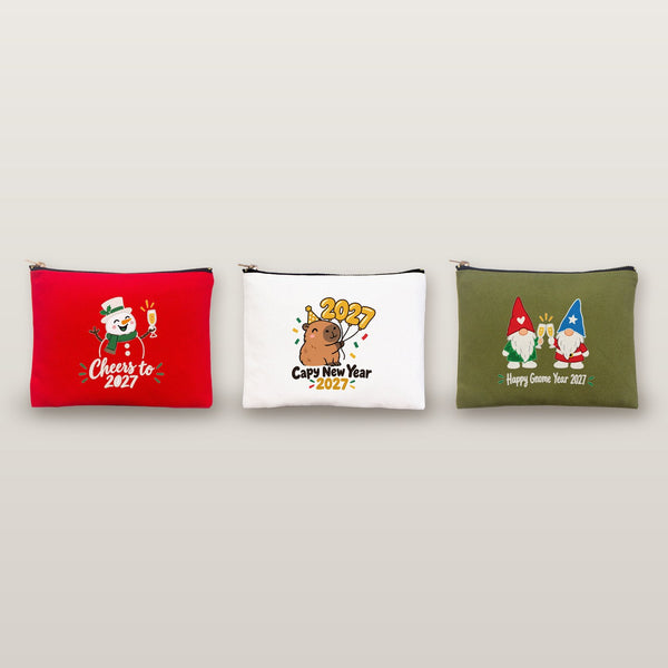 Studio photo of three clutch bags with Cheers to 2027 snowman, Capy New Year 2027 and Happy Gnome Year 2027 prints