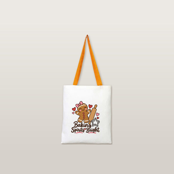 Mustard handle natural cotton tote bag with a Baking Spirits Bright gingerbread print on a plain studio background