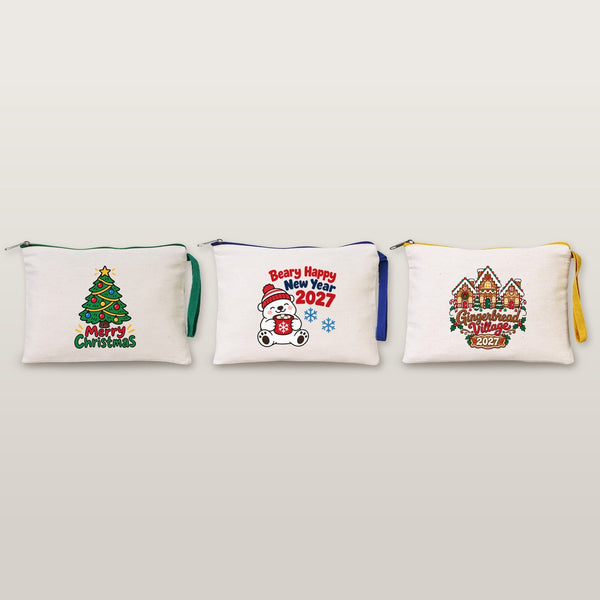 Studio photo of three cotton clutches with Merry Christmas tree, Beary Happy New Year 2027 and Gingerbread Village 2027 prints