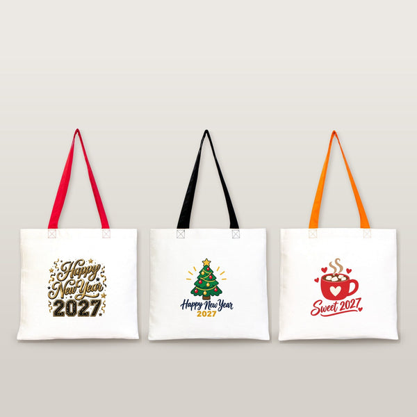 Studio photo of three cotton tote bags with red, black and orange handles and gold Happy New Year 2027, Christmas tree and Sweet 2027 prints