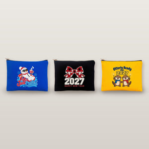 Studio photo of three clutch bags with Just Chillin snowman, buffalo plaid bow 2027 and Otterly Ready for 2027 prints