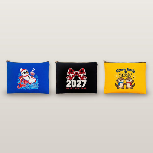 Studio photo of three clutch bags with Just Chillin snowman, buffalo plaid bow 2027 and Otterly Ready for 2027 prints