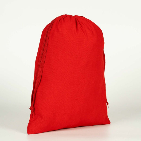 Real photo of a plain red cotton drawstring bag standing upright, showing its shape when filled