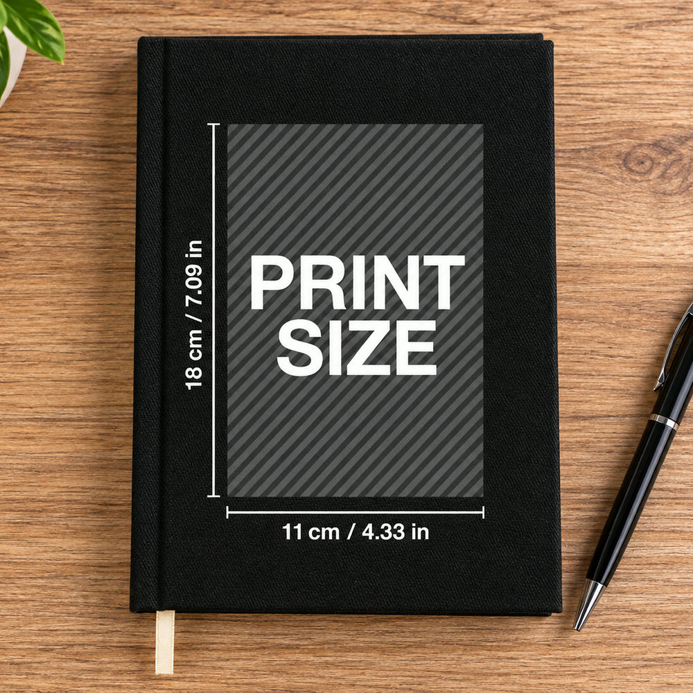 Black canvas notebook with your logo or image printed on the cover, on a wood desk with a pen – A5, 7.9 x 5.5 in (20 x 14 cm) | Pamusan.com