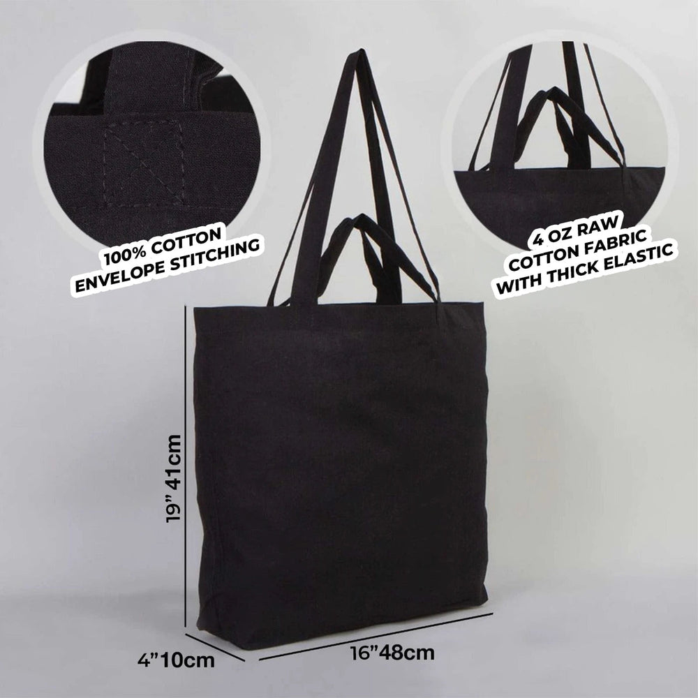 Black tote bag on a wooden floor with dimensions displayed
