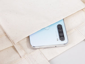 Smartphone with a reflective surface on a textured fabric background