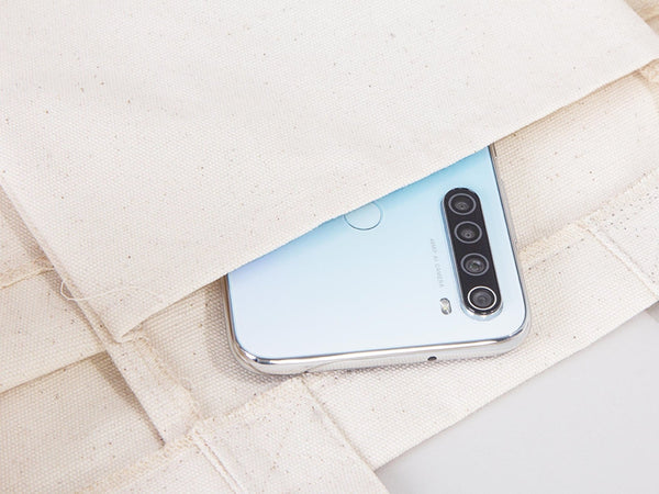 Smartphone with a reflective surface on a textured fabric background