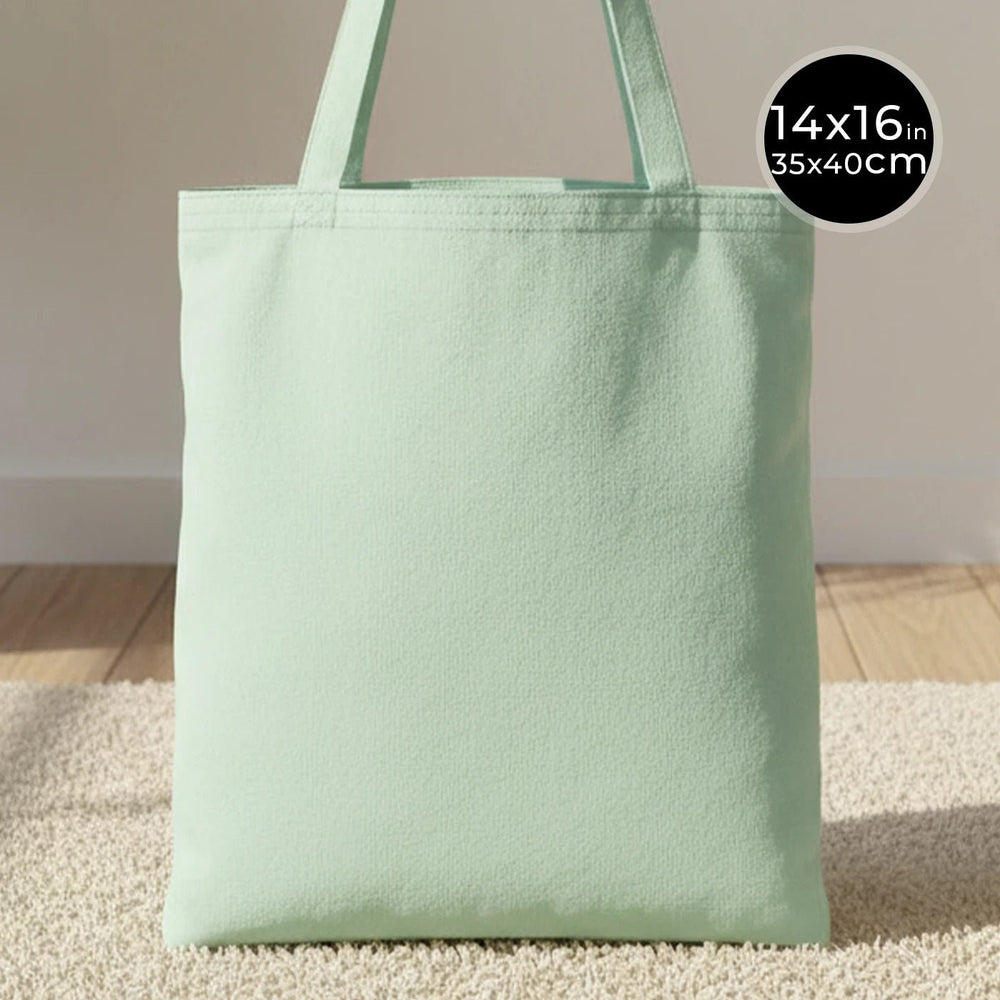 Light green tote bag on a neutral background with size label.