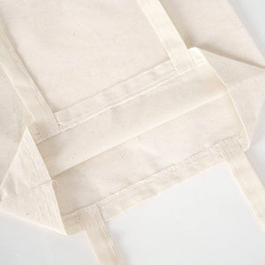 Close-up of beige fabric with a textured pattern on a white background