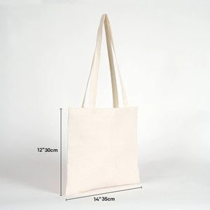 Beige tote bag with measurements on a white background
