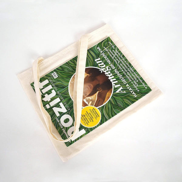 Tote bag with a green design featuring text and an image of a product on a white background