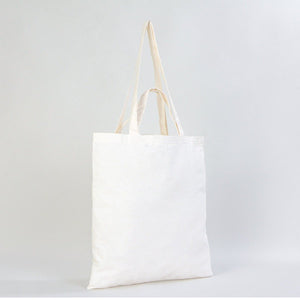 White tote bag with beige handles on a light gray background