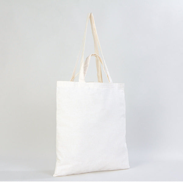 White tote bag with beige handles on a light gray background