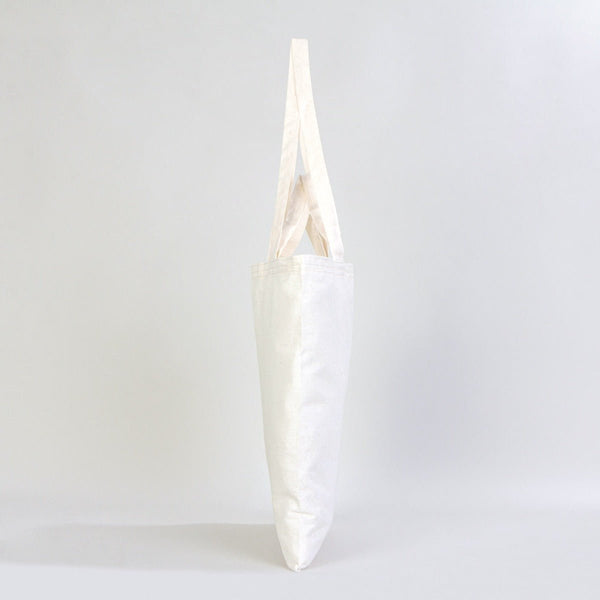 White vase with a unique design on a light gray background