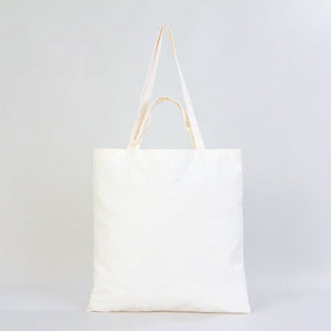 White tote bag with beige straps on a light gray background