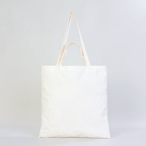 White tote bag with beige straps on a light gray background