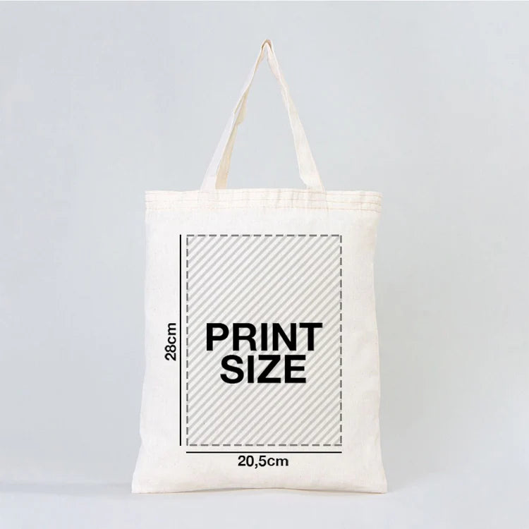 White tote bag with printed measurement details on a light gray background