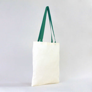 White tote bag with green straps on a light gray background