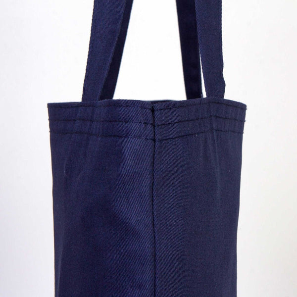 Navy blue tote bag with straps on a white background