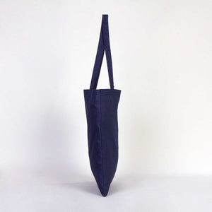 Navy blue tote bag with a strap on a white background