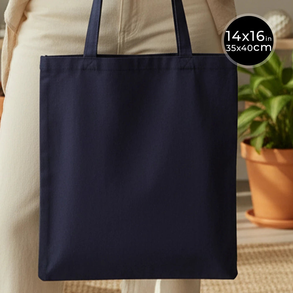Navy tote bag held by a person with dimensions displayed