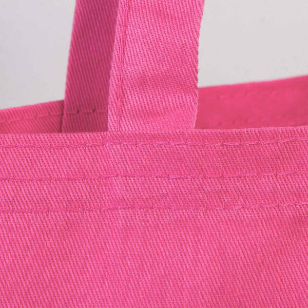 Close-up of a pink tote bag with handles on a light gray background