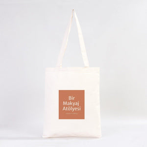 Tote bag with a brown square and text on a white background
