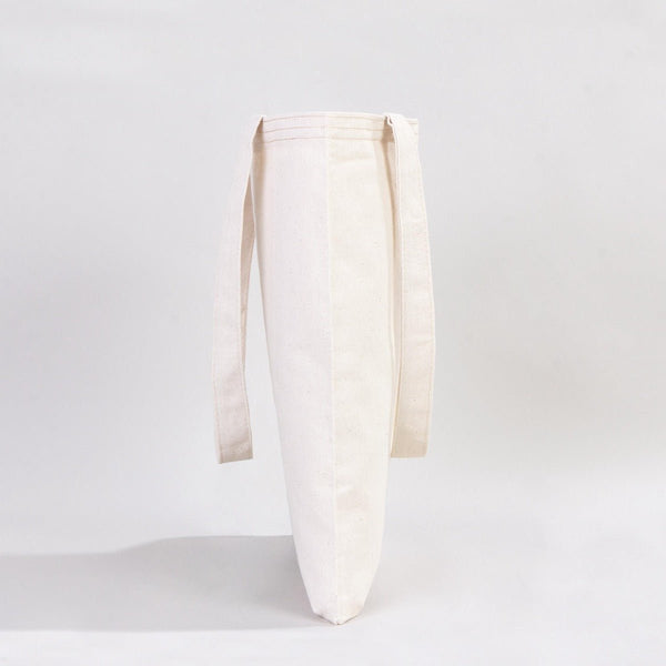 White ceramic vase with a ribbed texture on a light gray background
