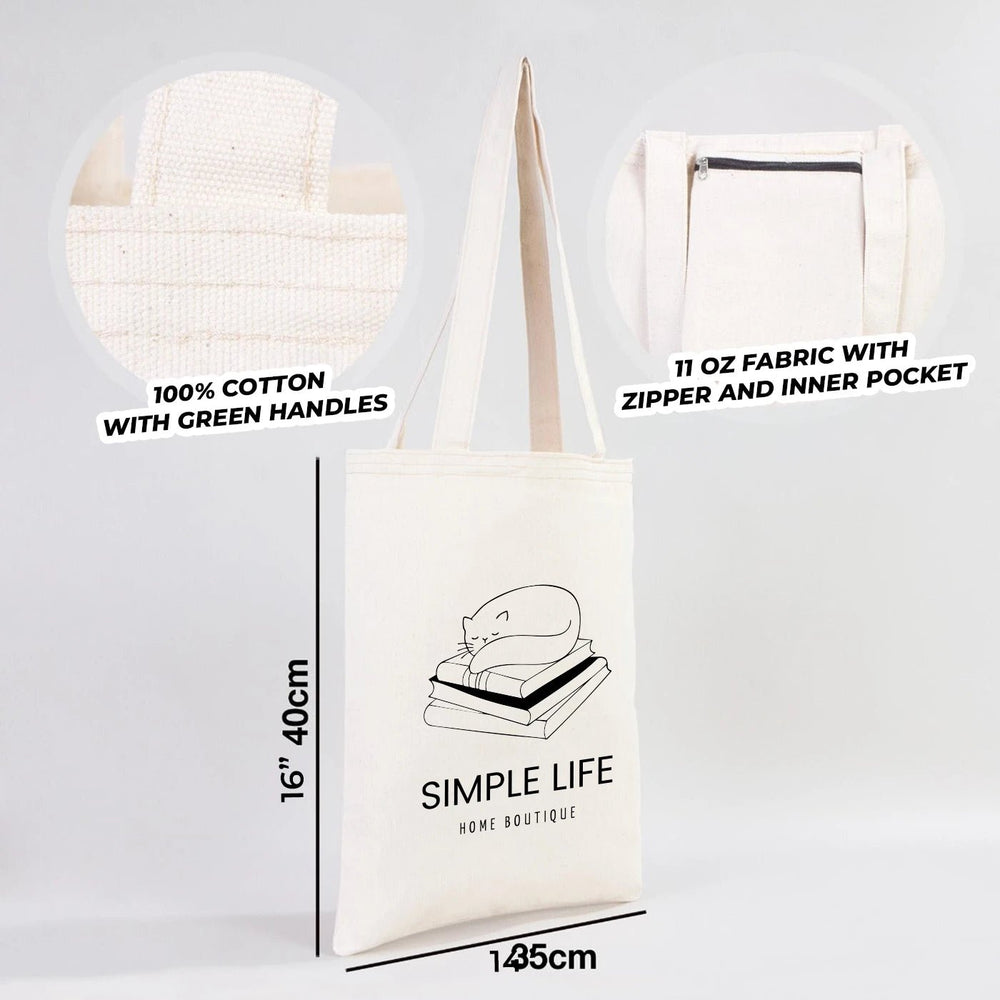 Beige tote bag with customizable text on a wooden surface with a plant and books in the background