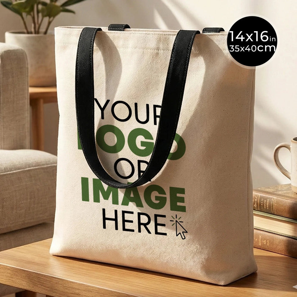 Beige tote bag with black handles on a wooden surface, with text 'Your logo or image here'.