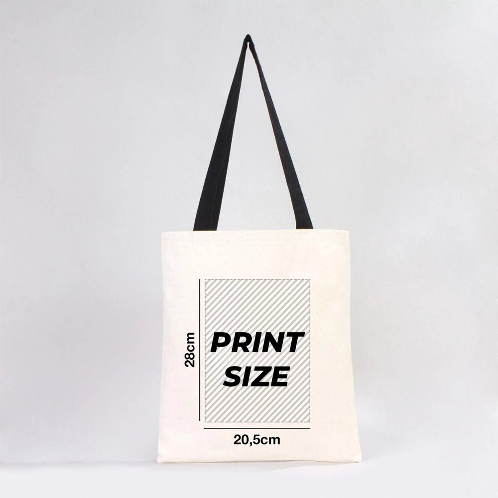 Beige tote bag with black handles on a wooden surface, with text 'Your logo or image here'.