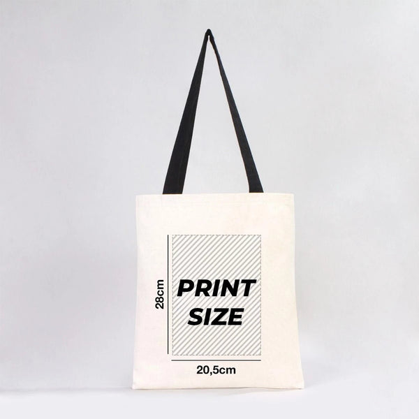 Tote bag with print size information on a light gray background