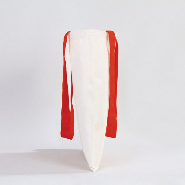 White pillow with red straps on a light gray background