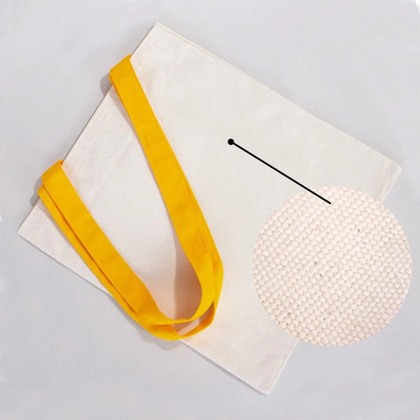 White clutch bag with yellow strap on a light gray background