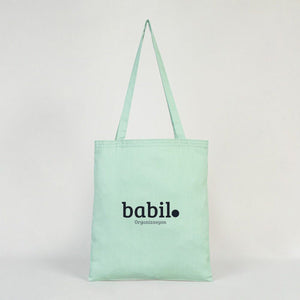 Mint green tote bag with 'babil' branding on a light gray background