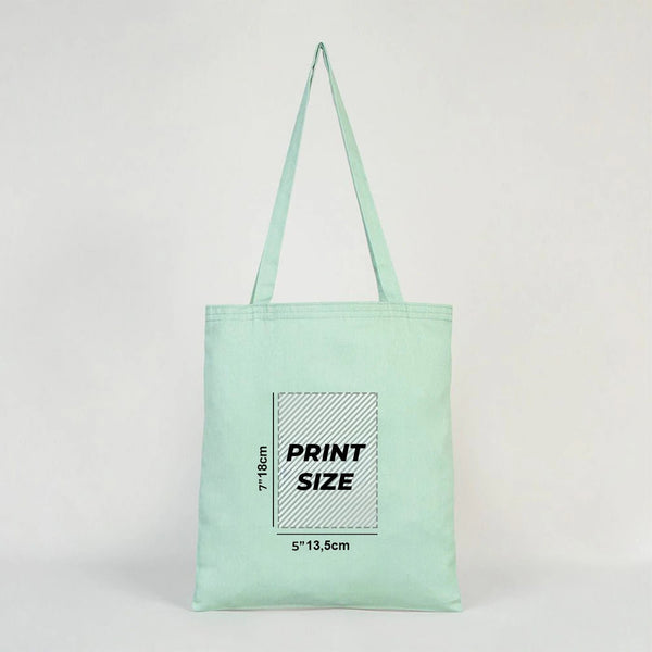 Mint green tote bag with print size information on a light gray background