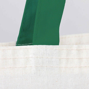 Close-up of a green fabric strip on a white textured surface