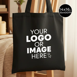Black tote bag with customizable text 'YOUR LOGO OR IMAGE HERE' on a neutral background