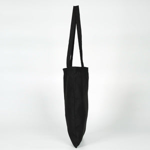 Black tote bag with a long strap on a white background