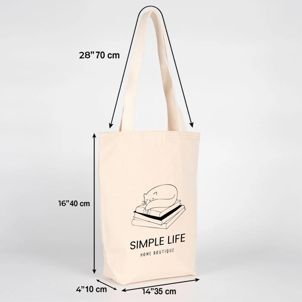 Beige tote bag with customizable text on a wooden surface