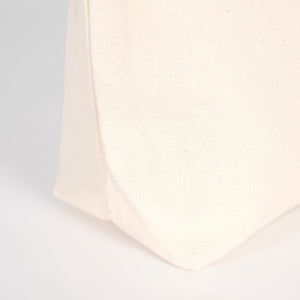 Close-up of a textured white fabric corner on a light gray background
