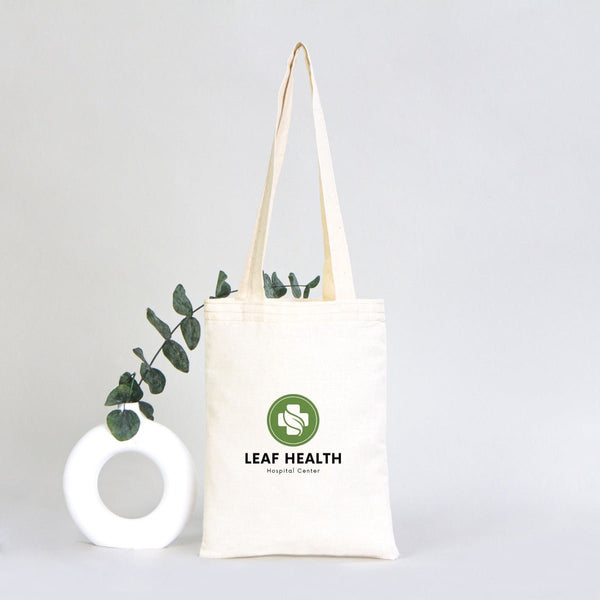 Tote bag with 'Leaf Health' logo and eucalyptus branch on a light gray background